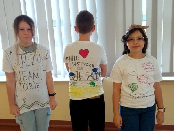 Uczniowie z klasy 5b prezentują swoje koszulki